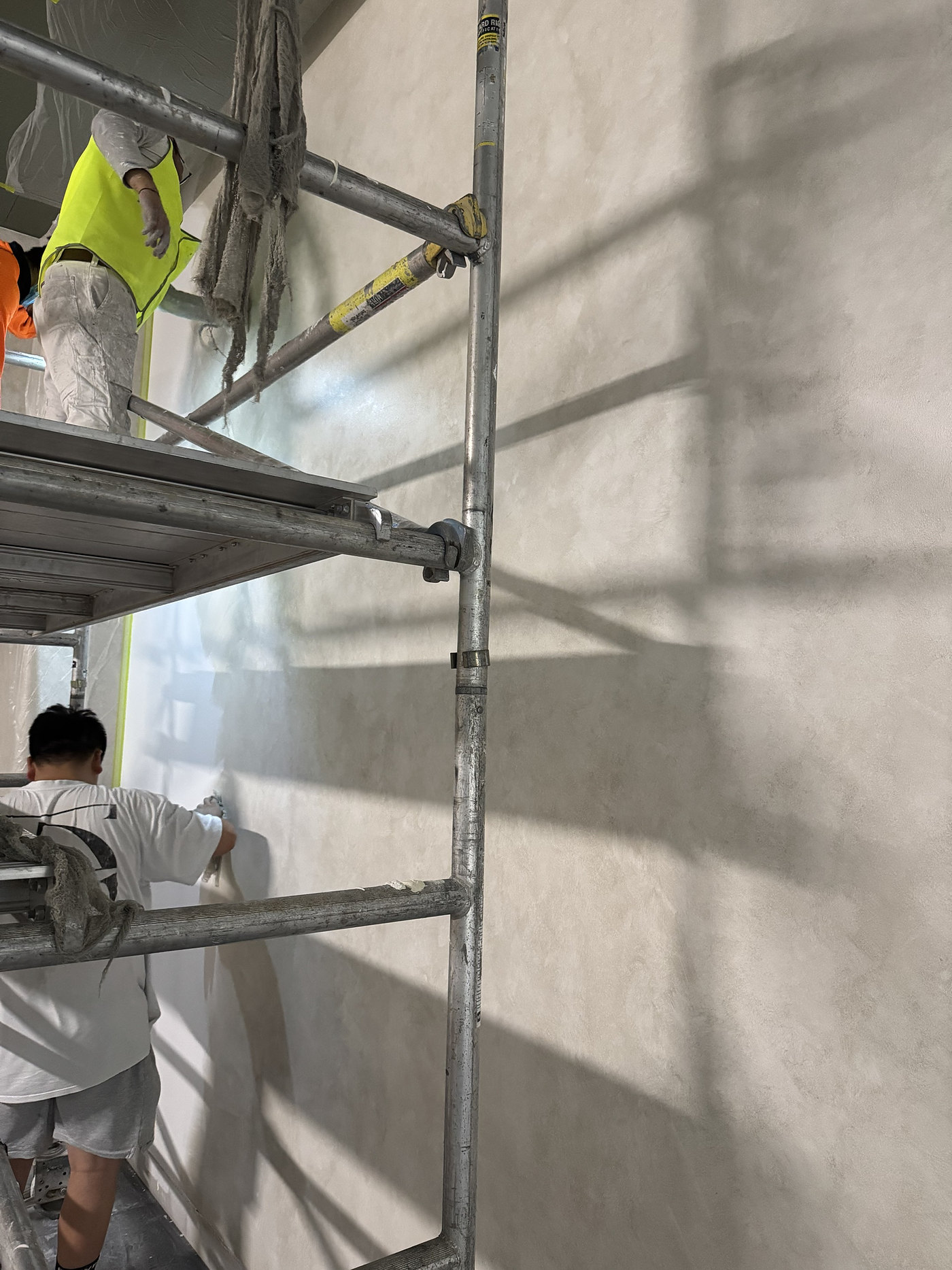 Vienna crew applying plaster from scaffolding