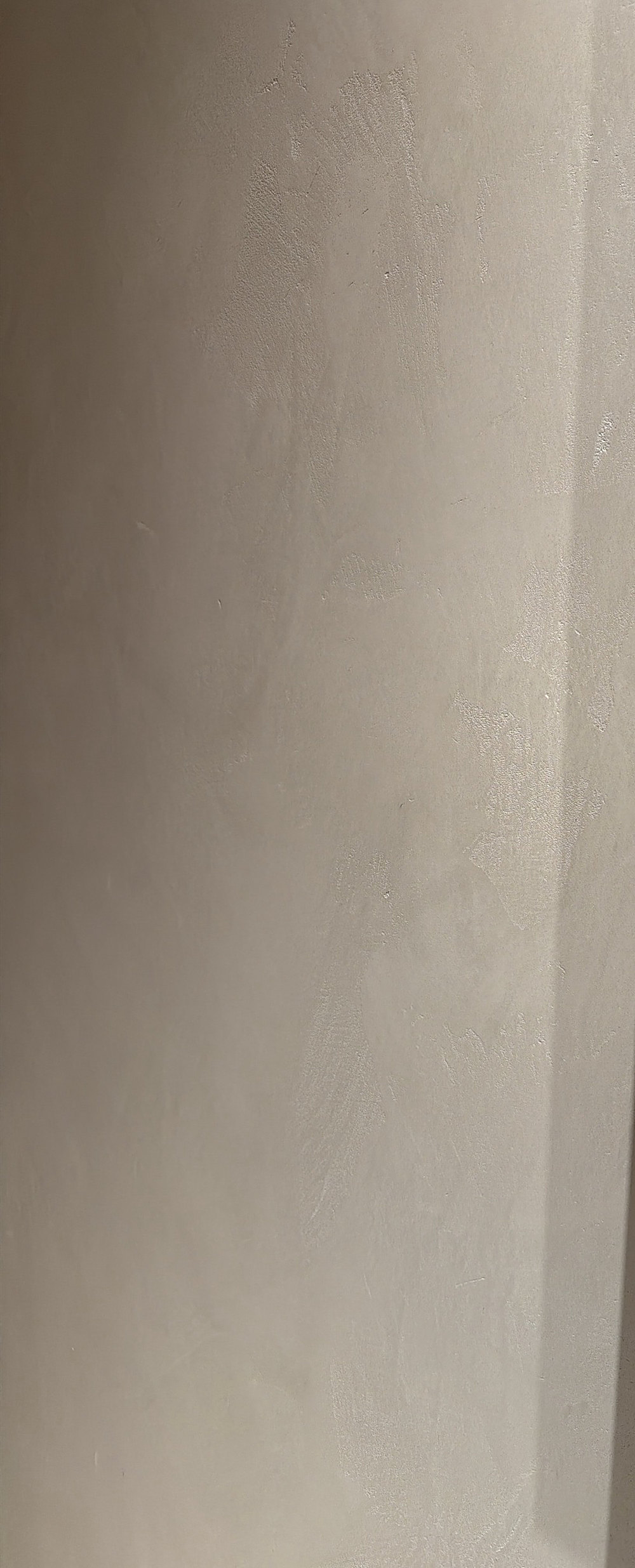 Warm white Venetian plaster in sunlight
